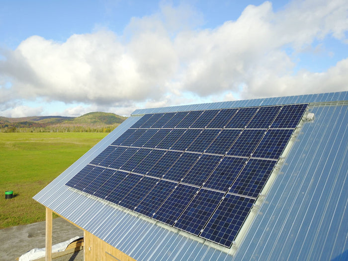 Solar Panel on a roof Grid-Tied Net-Metering Solar Panel System charging a Tesla EV car 