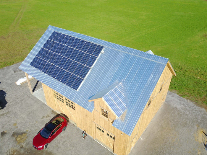 Grid-Tied Net-Metering Solar Panel System charging a Tesla EV car - aerial view